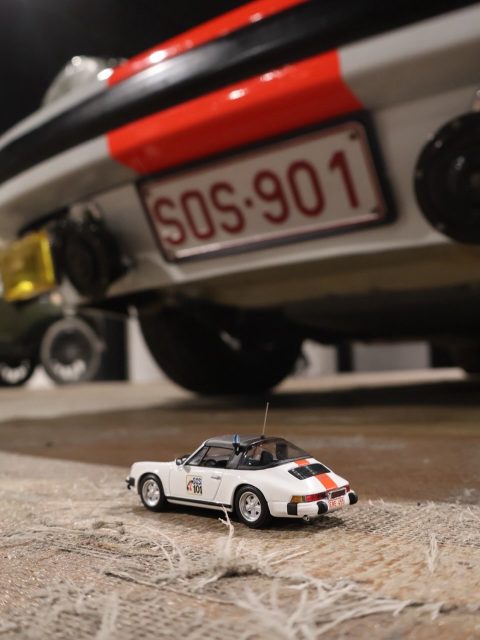SOS 901. A call sign that meant one thing on Belgian motorways in the 1970s and 1980s: a Porsche 911 was on the way, and whatever you were doing, you were about to have a conversation about it. The Rijkswacht ran 911s for highway patrol duty from the late 1960s onwards, and the sight of one in full gendarmerie livery remains one of the most distinctive images in Porsche history.

This example was photographed inside the Frans van Haren collection at Metropole Druten. White bodywork, red and blue striping, period correct lettering, and the soft museum light that gave every detail room to breathe.

For the scale pairing, @minichamps_official delivered a faithful rendition that captures the proportions and the colour separation remarkably well.  @metropole.nl @minichampsofficial 

The full series is now live on miniflatsix.com.

Hint of what’s coming next on the feed but now on miniflatsix.com a silver 356 with skis strapped to the back, photographed downstairs in the same Metropole Druten collection. Less highway patrol, more alpine getaway. A very different mood from the same building.